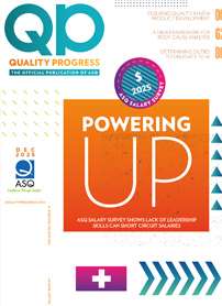 A black dice cup with colorful dice spilling out