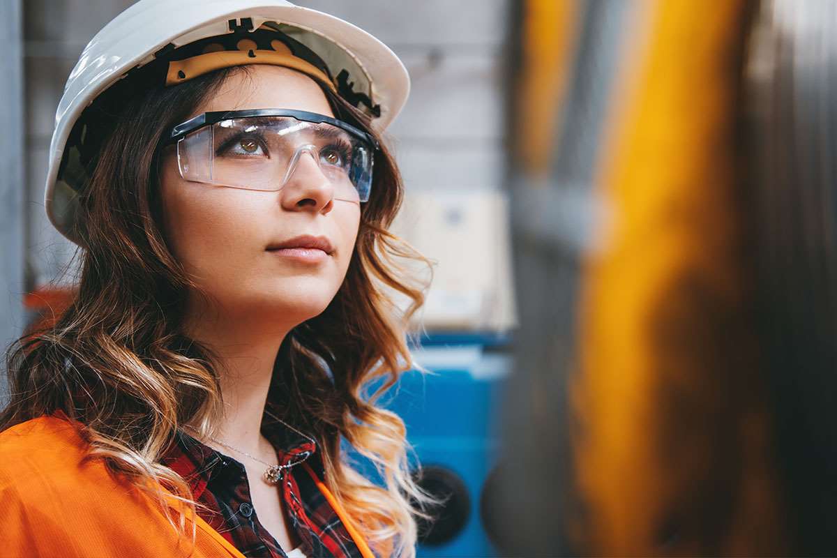Woman wearing safety glasses and hard hat